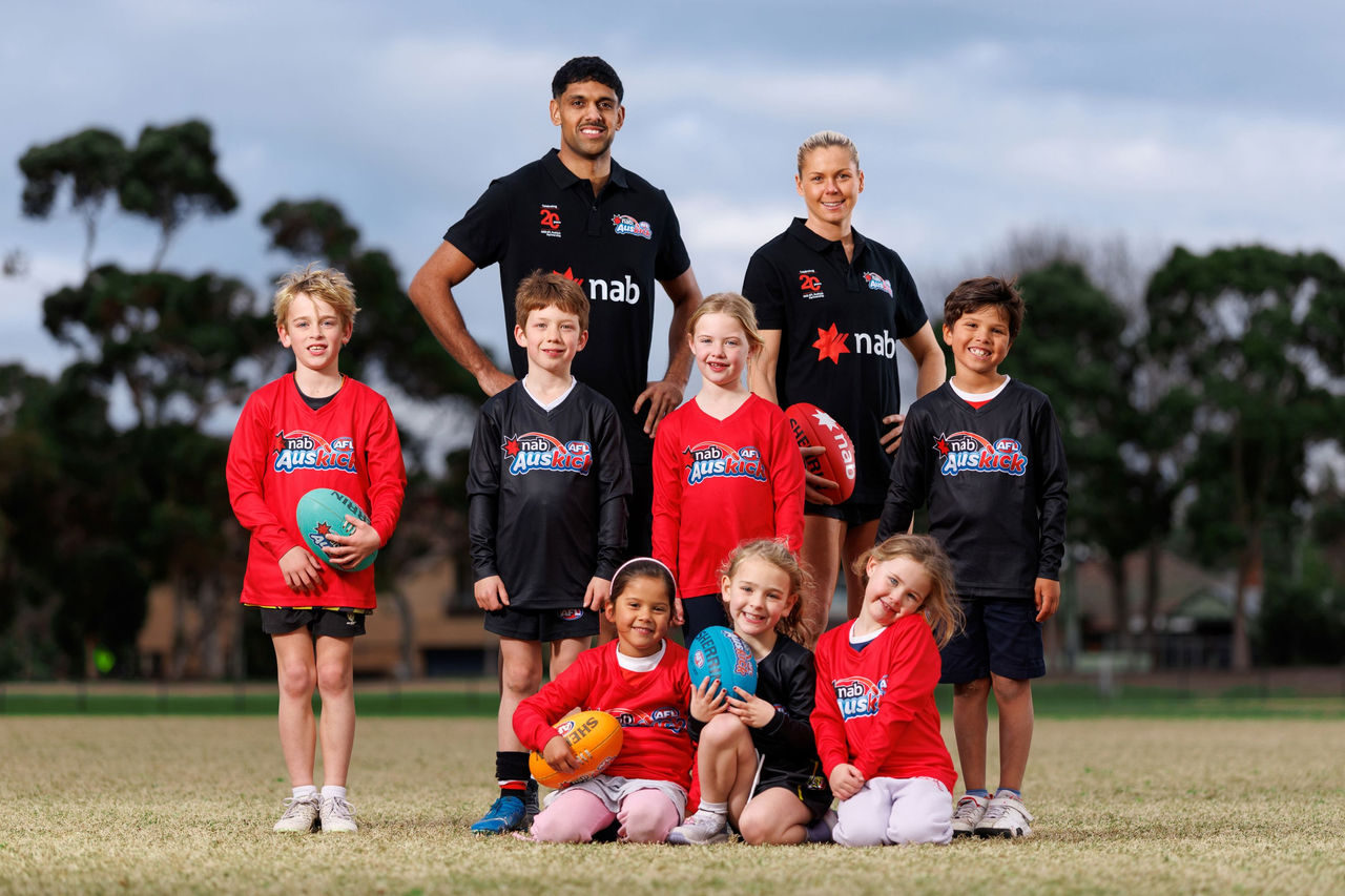 AFL player Nasiah Wanganeen-Milera and AFLW player Katie Brennan with NAB AFL Auskickers to celebrate 20 years of NAB's partnership with AFL Auskick