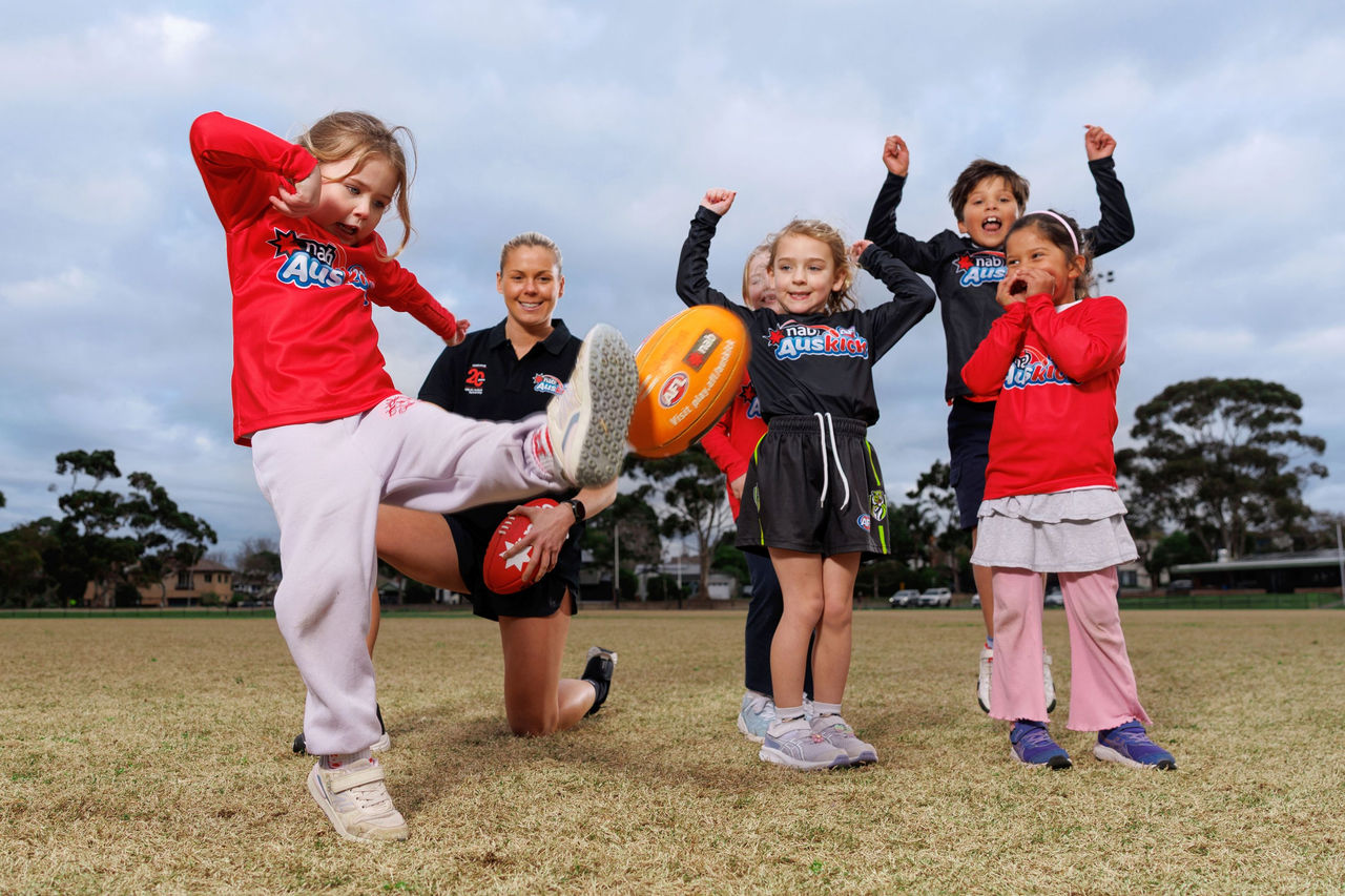 All Stars team member Katie Brennan with NAB AFL Auskickers