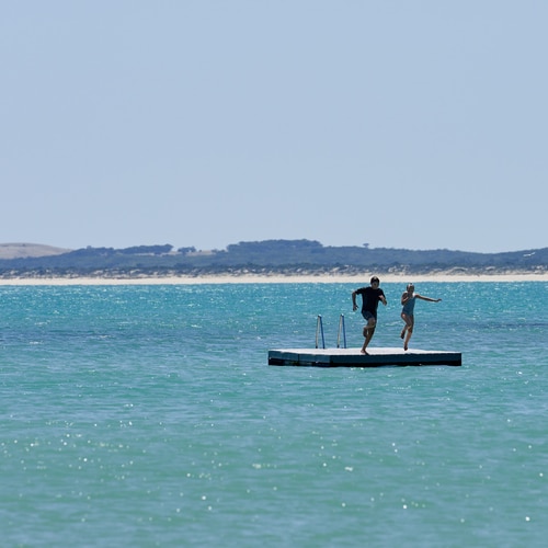 children jumping water travel